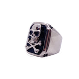 Silver ring with skull design on a white background