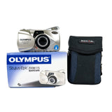 Olympus digital camera with packaging and a black case on a white background