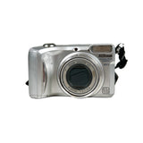 Silver Nikon digital camera on a white background
