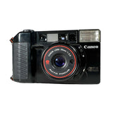 Black Canon camera with red accents on a white background