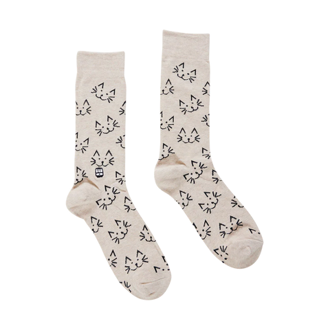 Pair of beige socks with black cat pattern on a white background