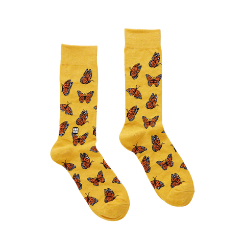 Yellow socks with butterfly pattern on a white background