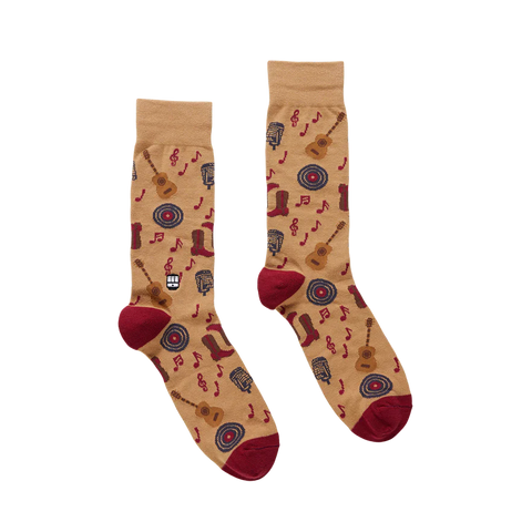 Pair of socks with guitar and music note pattern on a beige background