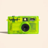 Clear green camera with 'Camp Snap' branding on a beige background