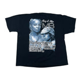 A black short-sleeve graphic T-shirt laid flat on a white fabric background. The front features a large blue-toned photo print of Mary J.