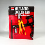 A vintage Marlboro cooler bag package standing upright on a light gray background. The box features a red cooler bag design with black trim, a black handle graphic, and a yellow-orange zipper pull detail.