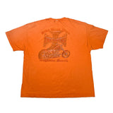 An orange short-sleeve t-shirt laid flat on a white surface, featuring a faded brown graphic on the back with a motorcycle and the text 'Mike Rockweller Choppers' and 'Magazine Monthly'.