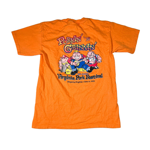 Orange t-shirt with cartoon pigs and text on a white background