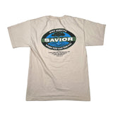 A beige short-sleeve t-shirt laid flat on a white background, showing the back side with a large oval graphic that reads 'WHY SURVIVE SAVIOR WHEN YOU CAN THRIVE!' in blue, green, and black.
