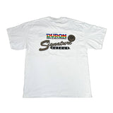 A white short-sleeve t-shirt laid flat on a white surface, featuring a 'DURON Parts & Windcover' and 'Signature Select' graphic printed on the chest.