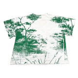 White t-shirt with green nature print on a white background