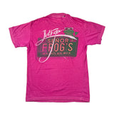 A bright pink heathered t-shirt laid flat on a white background, featuring a graphic on the back with a green frog wearing sunglasses, the text 'Let's go SENOR FROG'S MACATLAN, MEX.' in pink and white.