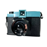 Vintage camera with a turquoise top on a white background