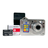 Sony digital camera with memory cards on a white background