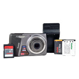 Digital camera with battery, memory card, and accessories on a white background