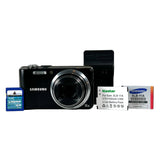 Black camera with Samsung battery and memory card on a white background