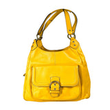 Yellow handbag with a gold buckle on a light gray background