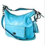 Turquoise handbag with a tassel on a white background