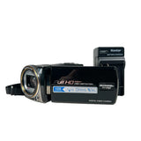 Digital video camera with battery charger on a white background