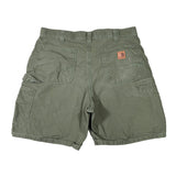 Green shorts with a brand logo on a white background