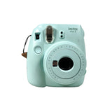 Mint green Instax camera on a white background
