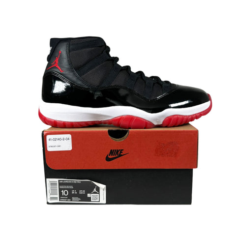 Black and red high-top sneaker on a Nike box with a gray background
