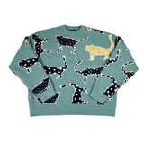 Green sweater with black and white dog pattern on a white background