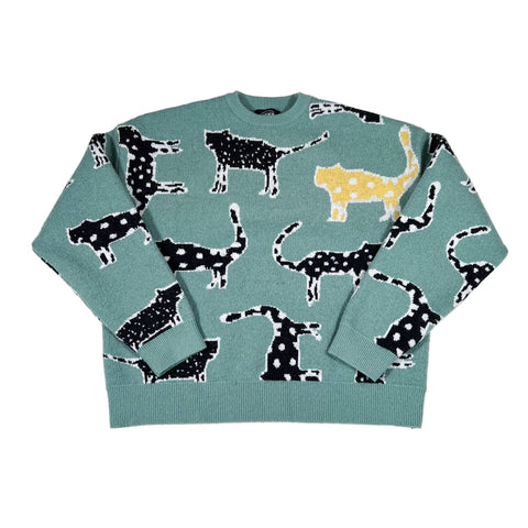 Green sweater with black and white dog pattern on a white background