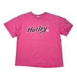 A pink short-sleeve Hurley t-shirt laid flat on a white background, featuring the Hurley logo printed across the chest in black and white.