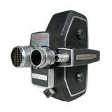 A vintage Bilt Howard System-X film camera with a black textured leather body and silver chrome metal accents, photographed on a neutral light gray background.