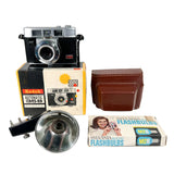 Vintage Kodak camera with accessories on a white background