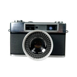 Vintage camera with a prominent lens on a white background