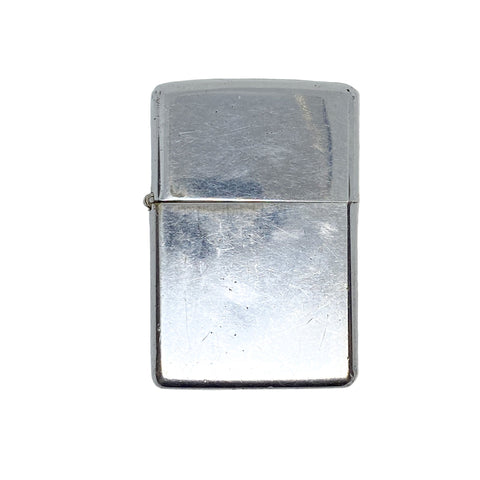 Silver Zippo lighter on a textured white background