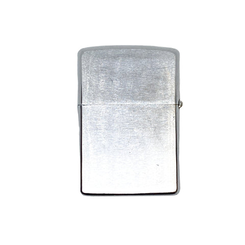 Silver lighter on a textured white surface