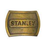 Brass belt buckle with 'STANLEY' engraving on a white background