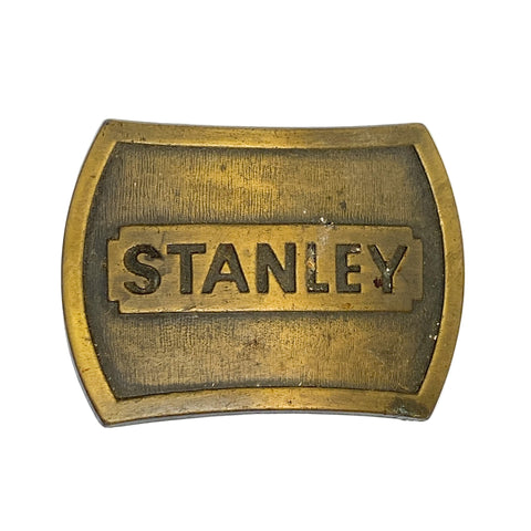 Brass belt buckle with 'STANLEY' engraving on a white background
