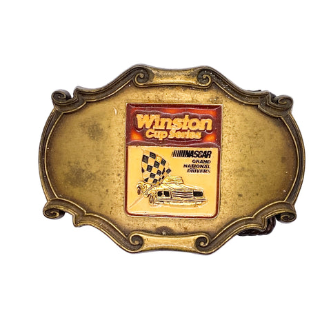 Gold belt buckle with Winston Cup Series and NASCAR logo on a white background