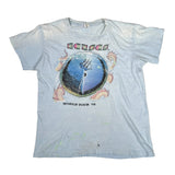 A light blue vintage band t-shirt for Kansas, featuring the 'World Tour '79' graphic with a yin-yang symbol and pink dragon illustrations, laid flat on a white background.