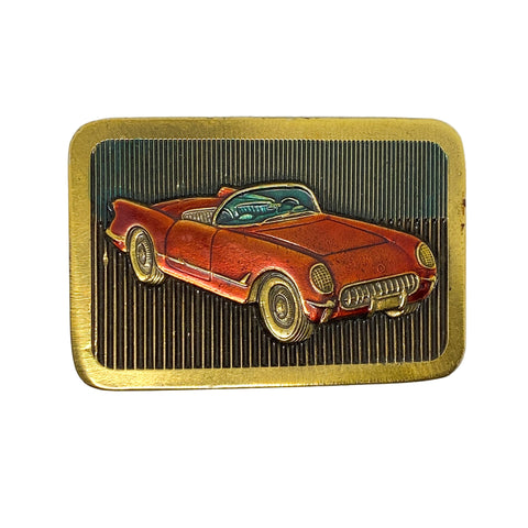 Belt buckle with a red classic car design on a white background