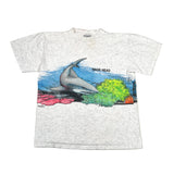 White t-shirt with a shark graphic and 'Nags Head' text on a gray background