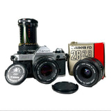 Canon camera with lens and packaging on a white background