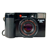 A vintage black Canon Rail SLR camera with a 40mm lens, featuring red accents around the lens and a textured grip, photographed against a light gray background.