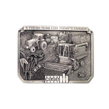 A rectangular silver-toned metal belt buckle featuring an embossed farm scene with a tractor, combine harvester, and other agricultural equipment. The buckle has a raised border with the text 'A FRESH TEAM FOR TODAY'S FARMER' at the top and 'CASE' at the bottom, set against a white textured background.