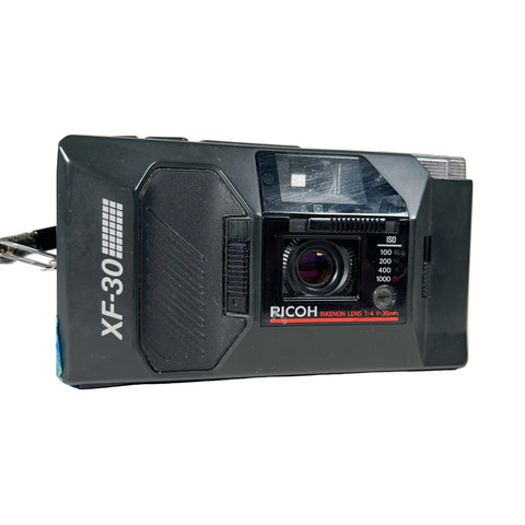 Ricoh XF-30 camera on a white background
