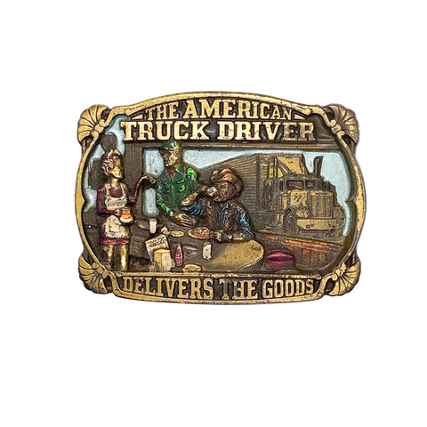 Belt buckle with 'The American Truck Driver Delivers the Goods' text and scene on a white background