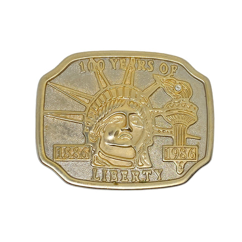 Gold-colored coin with '100 Years of Liberty' design on a white background