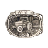 A silver-toned metal belt buckle featuring an engraved tractor and barn scene with the words 'MAGNUM SERIES' and 'CASE IH'.