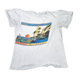 White t-shirt with a colorful graphic of a tropical scene on a white background