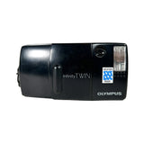 Black Olympus Infinity Twin camera on a white background
