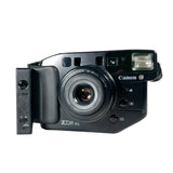 Canon camera with 'ZOOM XL' attachment on a white background